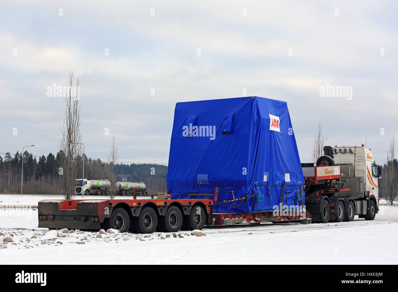 FORSSA, FINLAND - NOVEMBER 12, 2016: Side view of Volvo FH16 semi trailer oversize load transport parked on truck stop in winter. Stock Photo