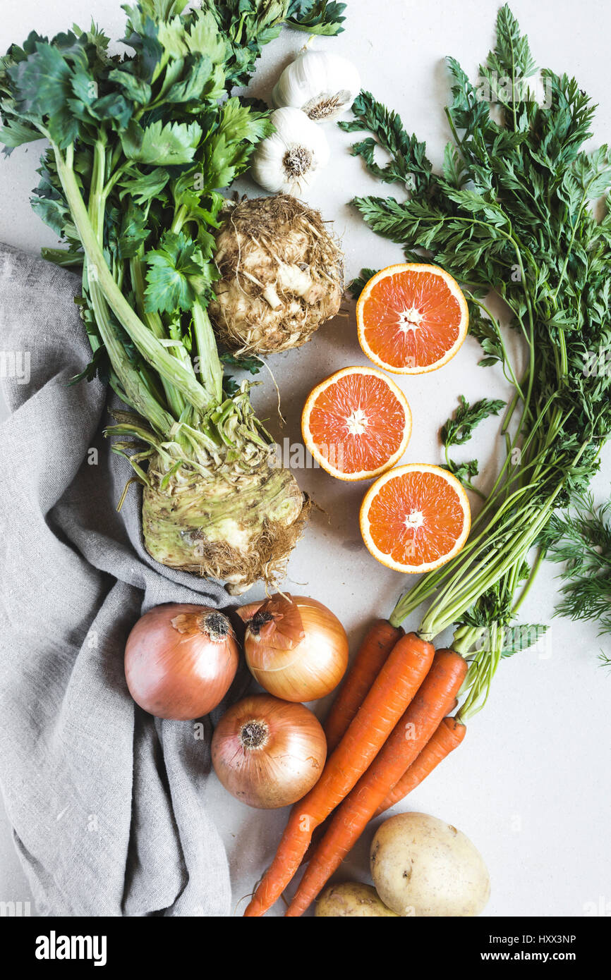 celery root, sliced oranges, carrots, and onions are photographed from