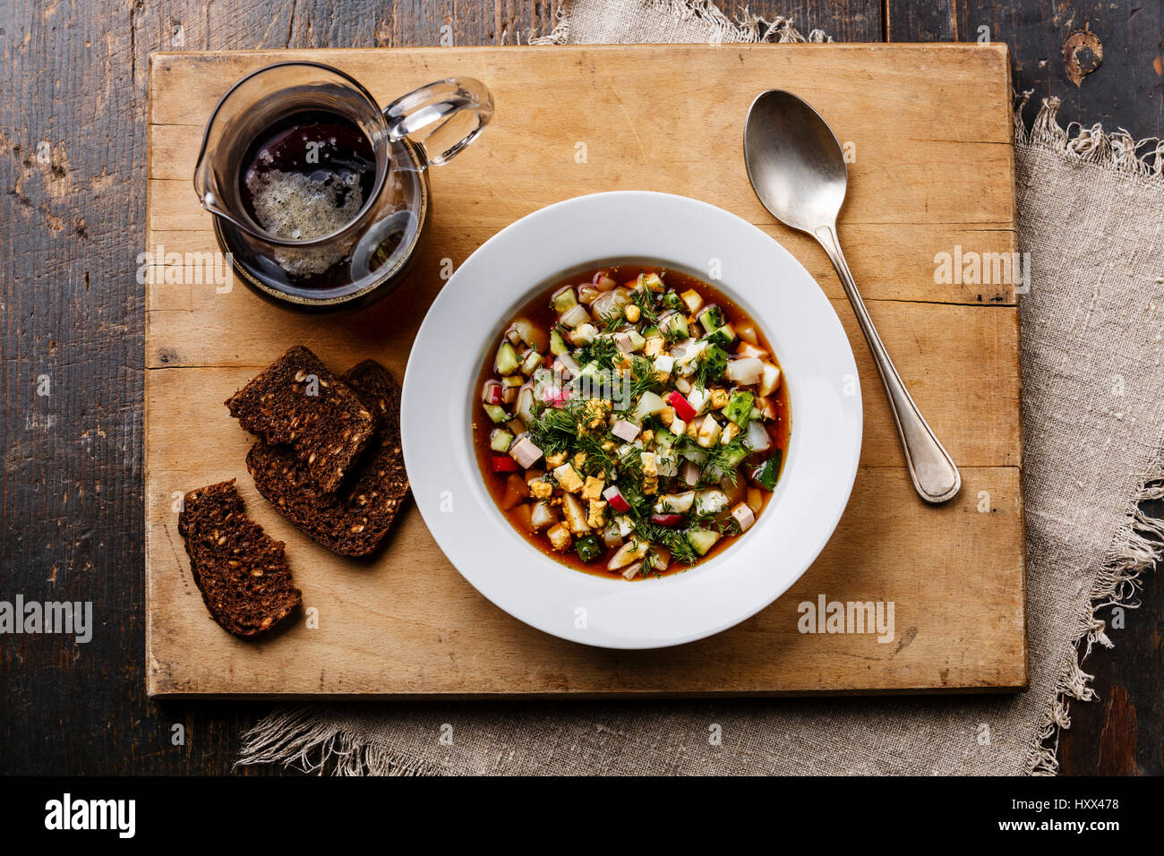 Cold Soup Okroshka with sausage, vegetables and kvass serving size on wooden table Stock Photo