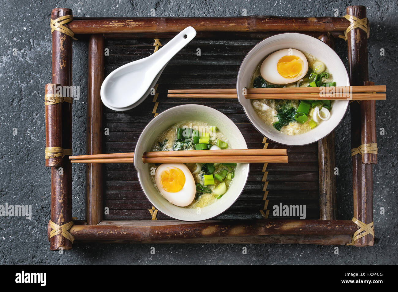Two bowls with asian style soup with scrambled eggs, half of marinated