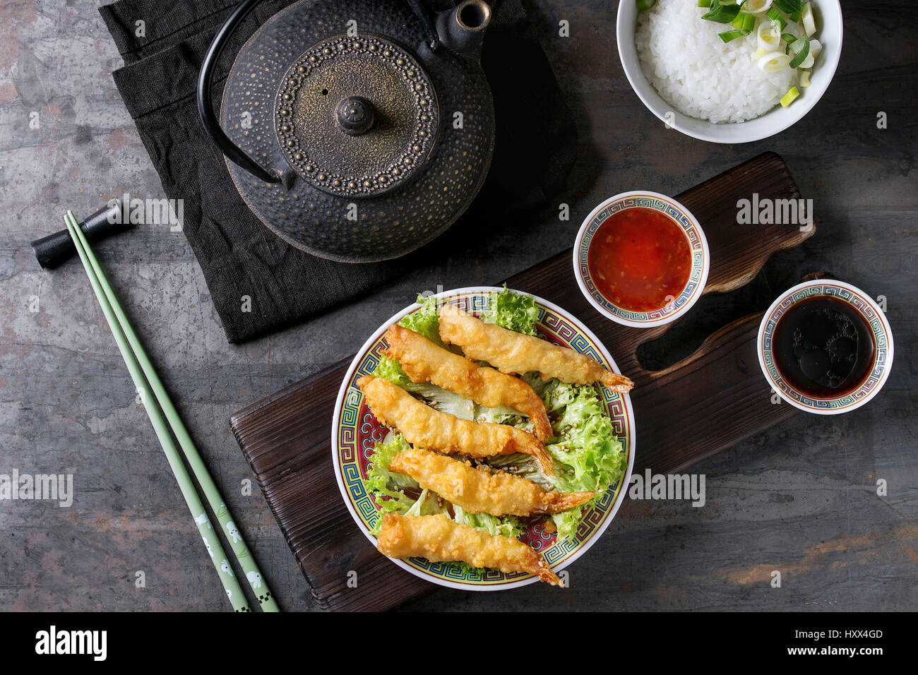 Fried tempura shrimps on lettuce salad with sauces. Served in traditional china plate with