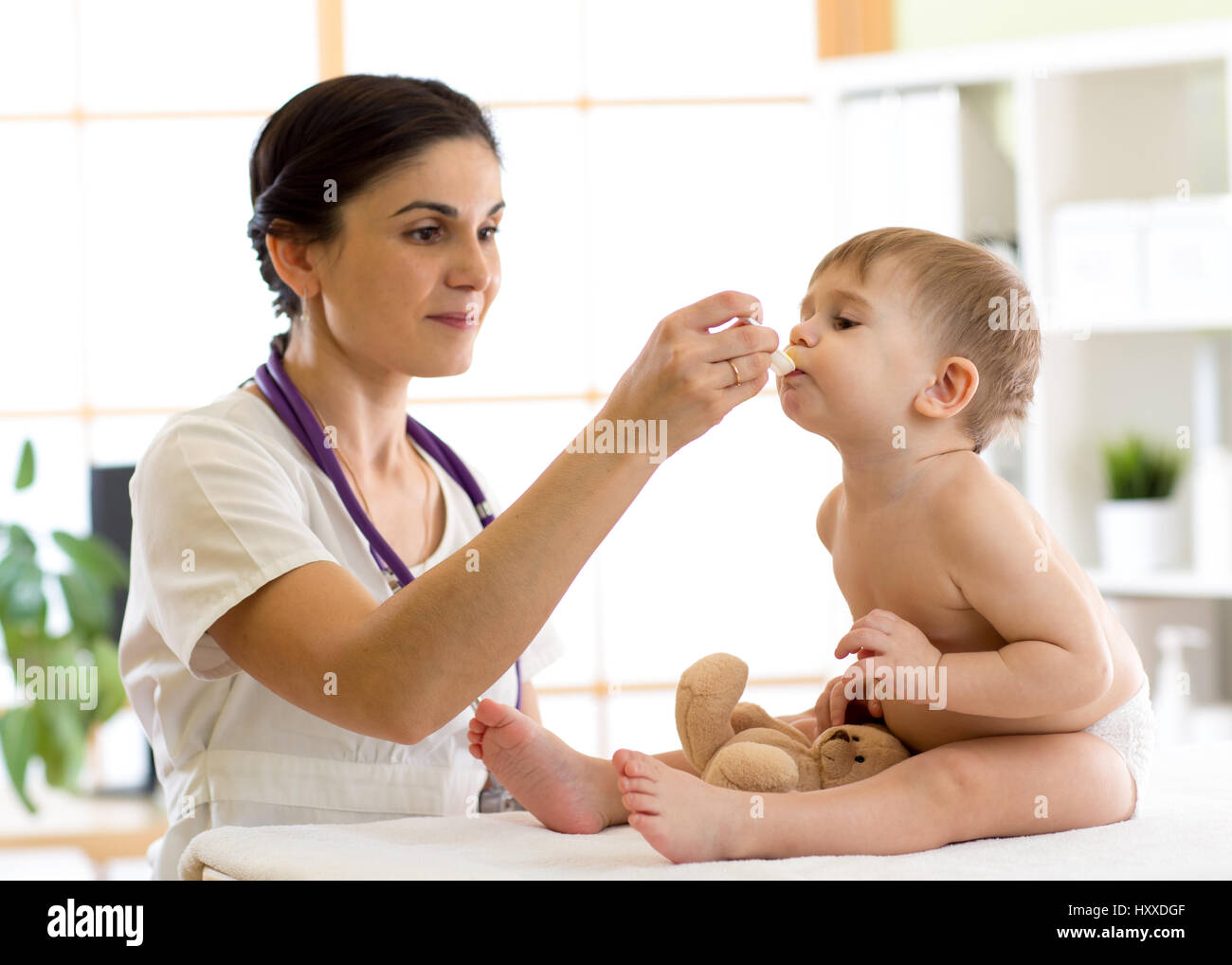 doctor giving medicament with a spoon Stock Photo