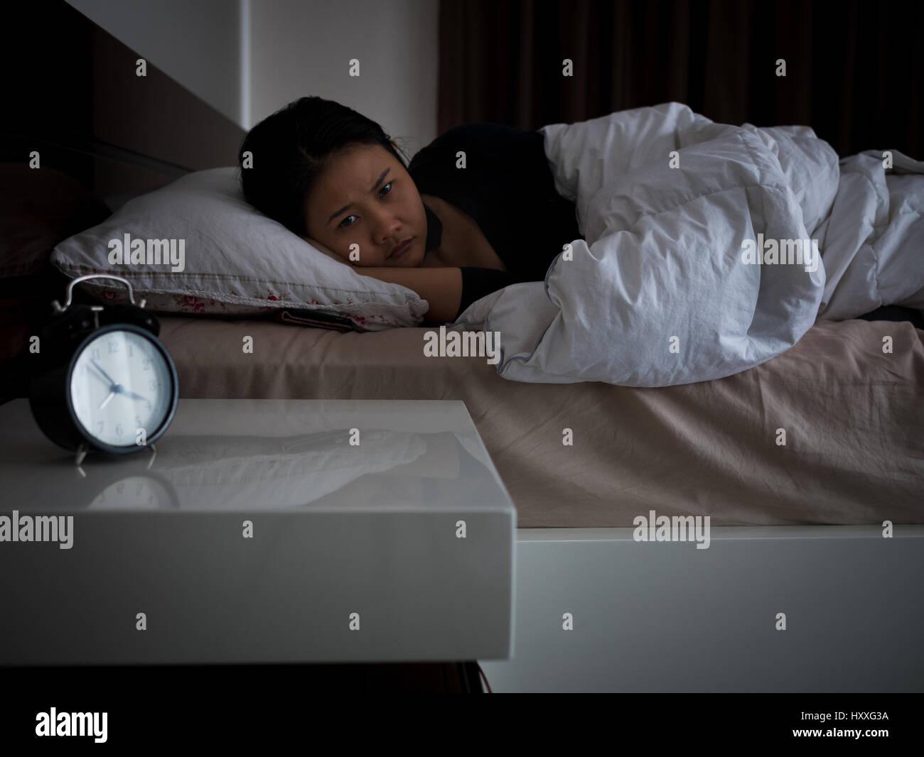 asian woman lying on bed awaking, insomnia concept Stock Photo