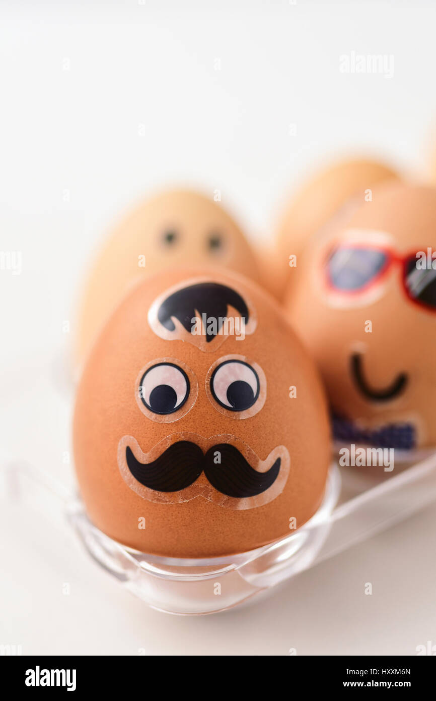 Closeup Of Some Easter Eggs Decorated With Funny Faces In A Plastic Egg Tray