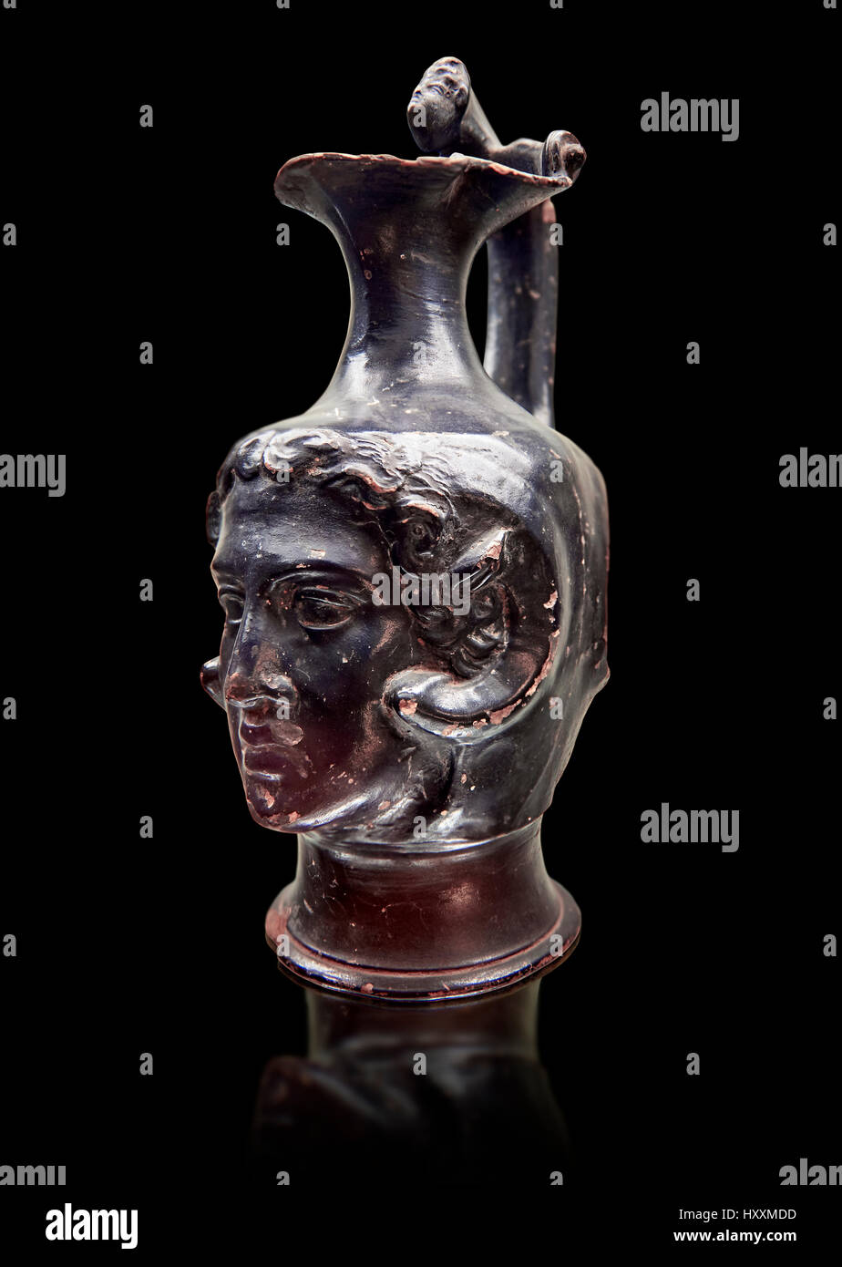 Etruscan bucchero jug with a face,  National Archaeological Museum Florence, Italy , black background Stock Photo