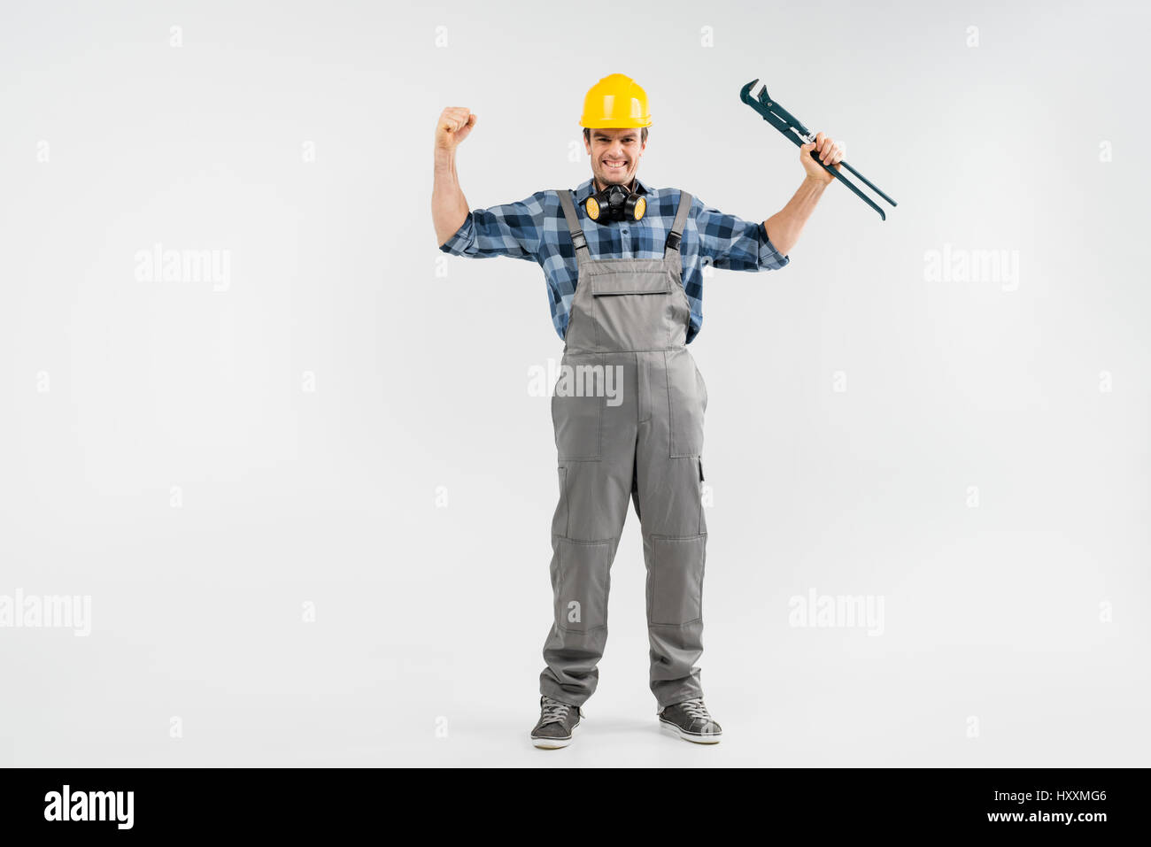 Full length portrait of cheerful professional male construction worker ...