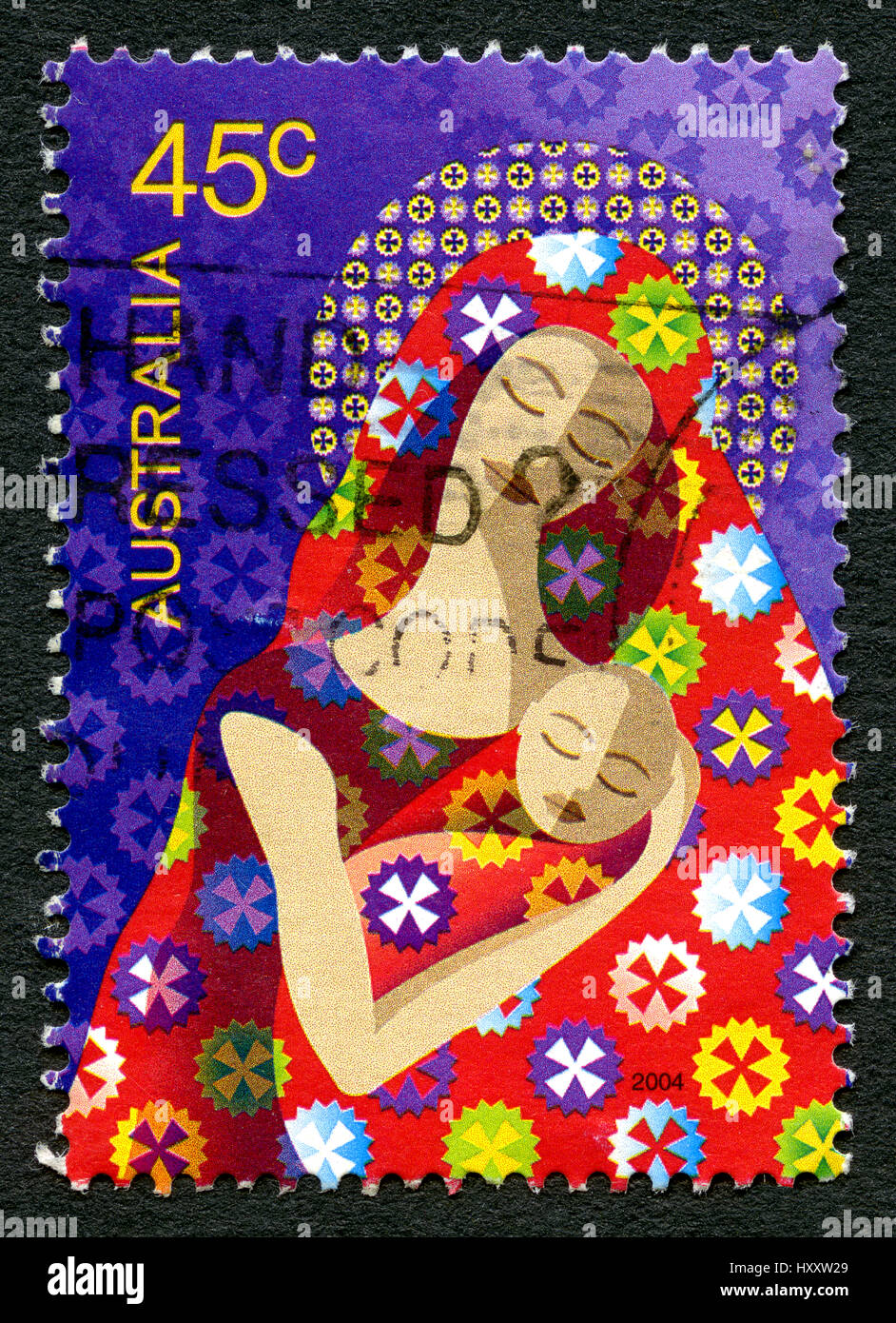 AUSTRALIA - CIRCA 2004: A used postage stamp from Australia, depicting an illustration of a mother and child, symbolising Mary and Baby Jesus, circa 2 Stock Photo