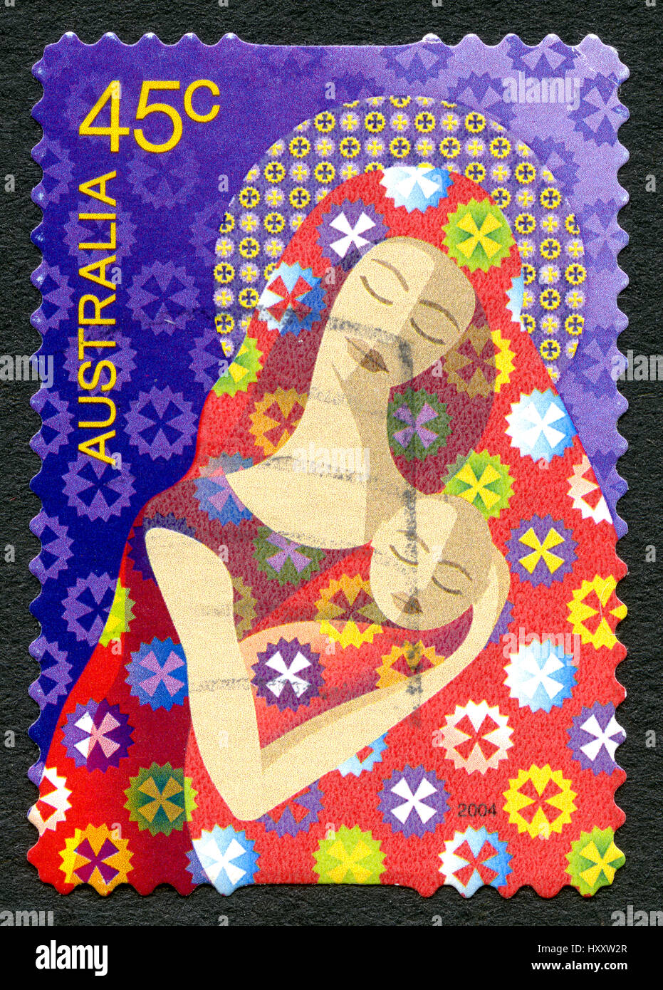 AUSTRALIA - CIRCA 2004: A used postage stamp from Australia, depicting an illustration of a mother and child, symbolising Mary and Baby Jesus, circa 2 Stock Photo