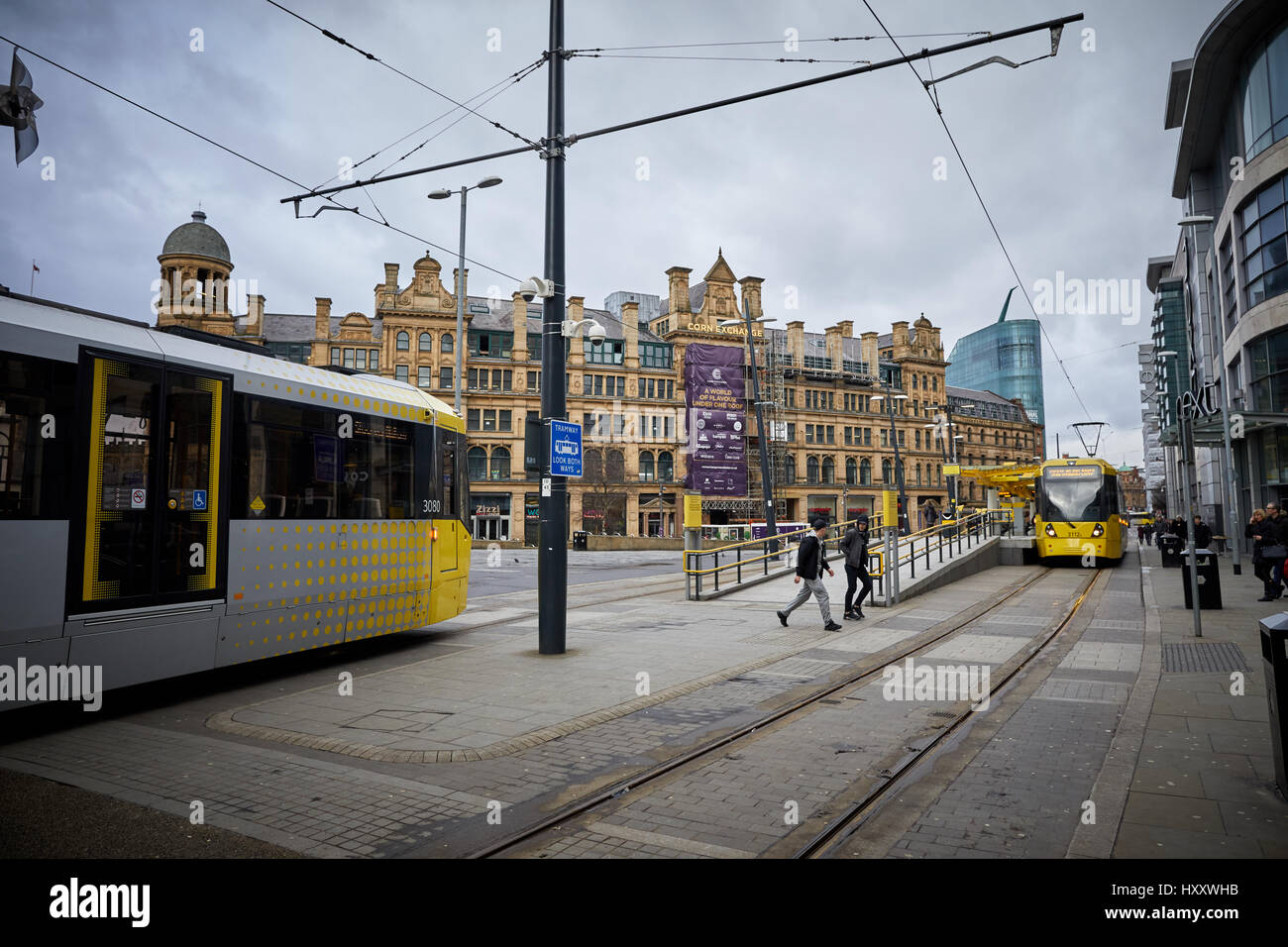 Metrolink commuter trams cross at Cornexchange complex at Exchange Square, Manchester,   England,UK Stock Photo