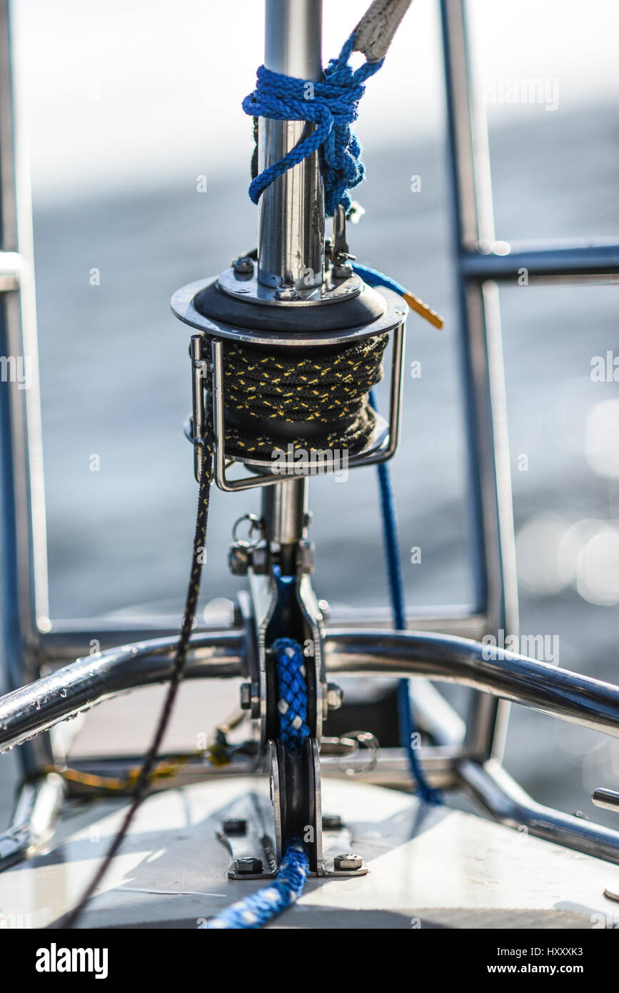 Bow pulpit with jib sail roller and rope on a small sailing boat Stock
