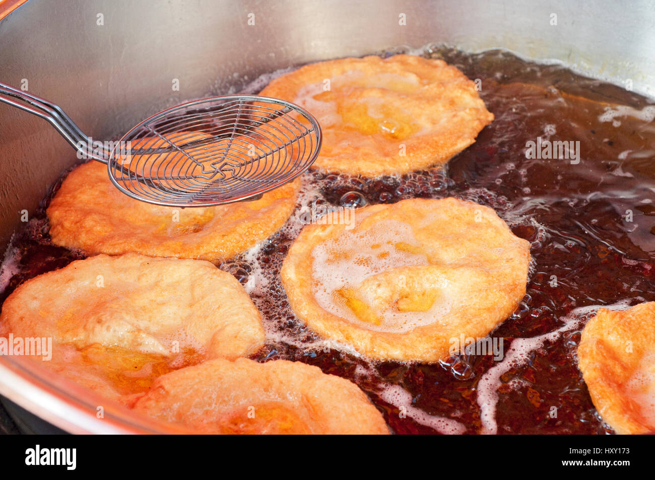 Italy, Lombardy, Street Food, Cooking Fitters Diped in Boiling Oil Stock Photo