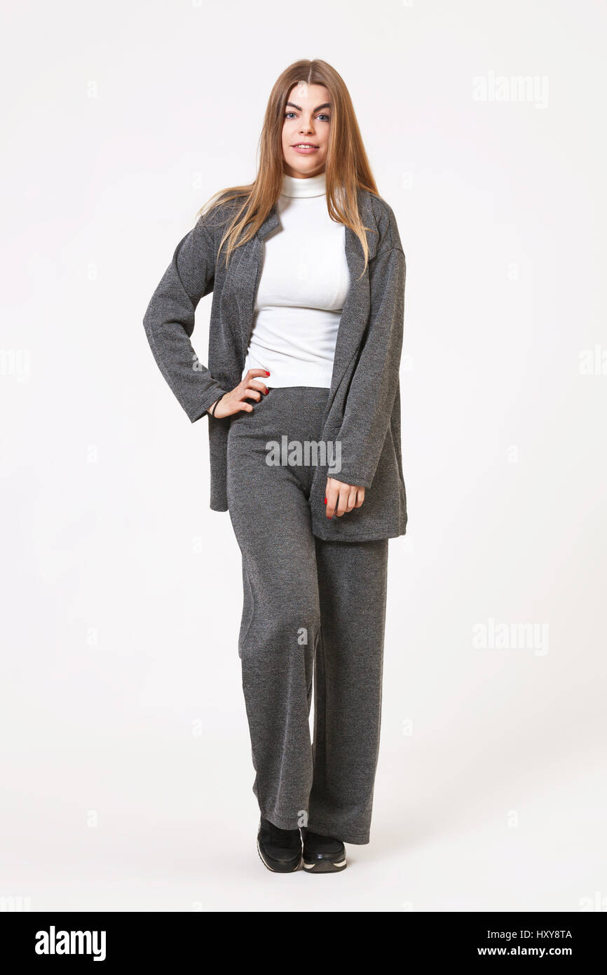 Studio portrait of beautiful young woman posing in gray costume on ...