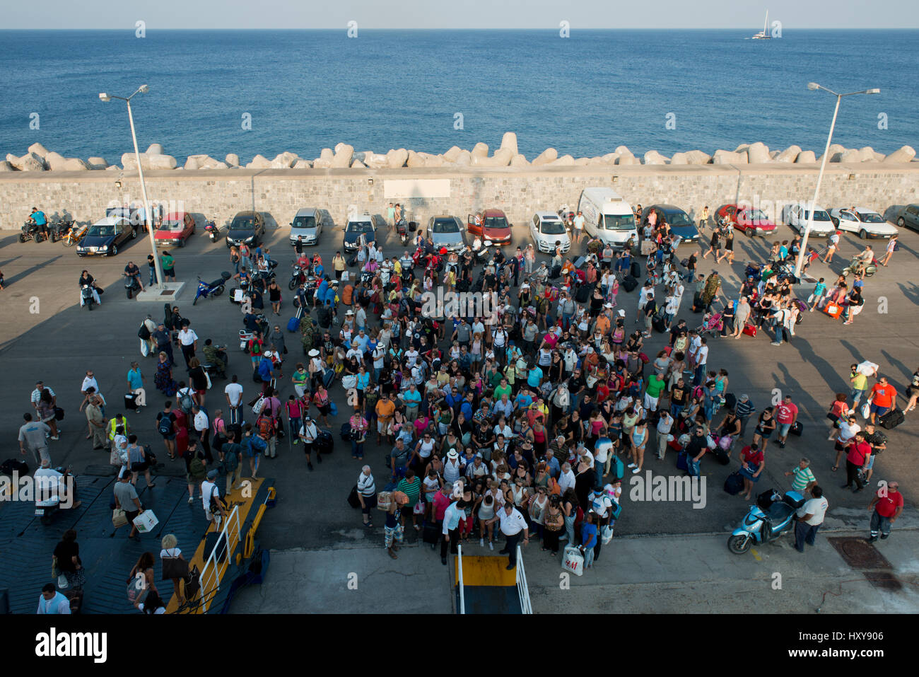 view from above on crowd waiting to board a ferry in the harbour of Rhodes, Dodecaneses, Greece Stock Photo