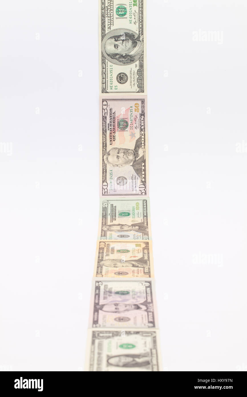 Strip of different us dollar banknotes on the white table Stock Photo ...