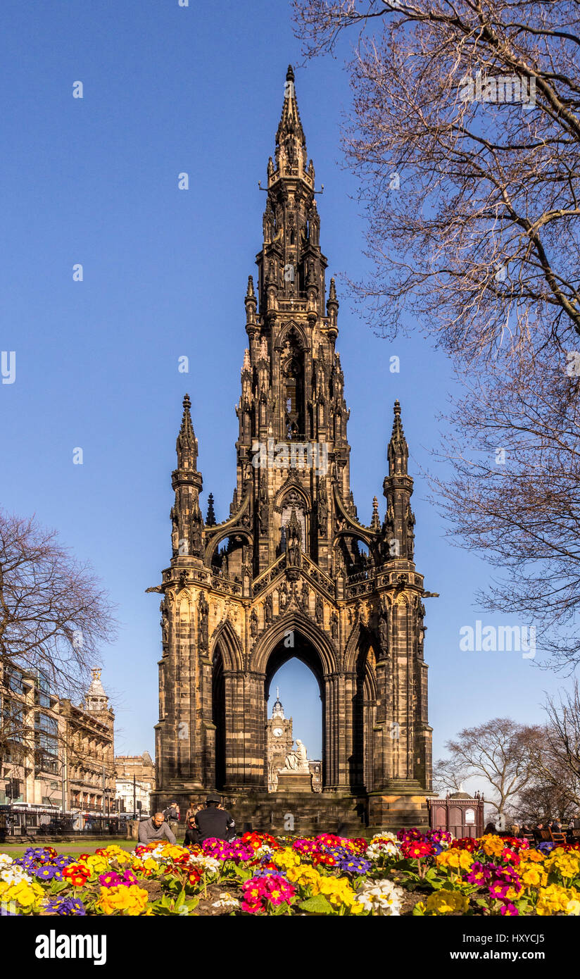 The Scott Monument, blackened from air pollution, with a colourful Spring flowerbed in the foreground. Princes Street Gardens East, Edinburgh. Stock Photo