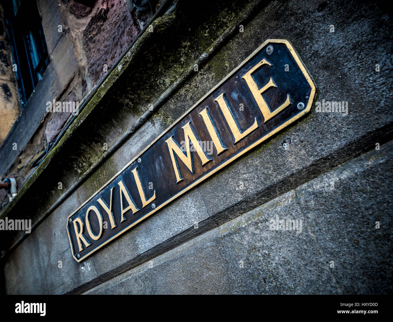Closeup of a Royal Mile sign fixed to a pollution blackened building exterior walled. Edinburgh, Scotland. Stock Photo