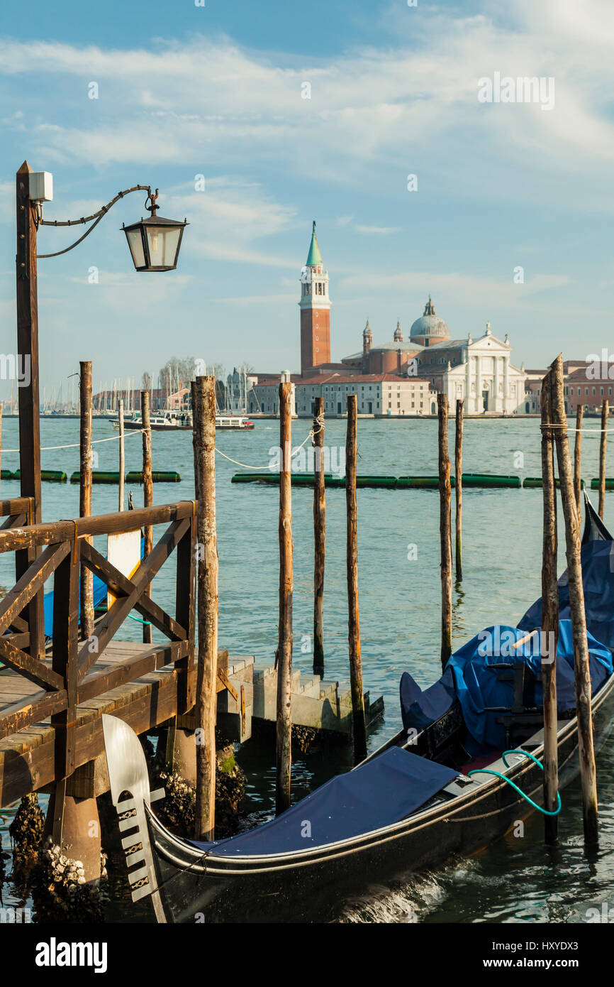 Gondola moored at San Marco basin in Venice. San Giorgio Maggiore church in the background. Stock Photo