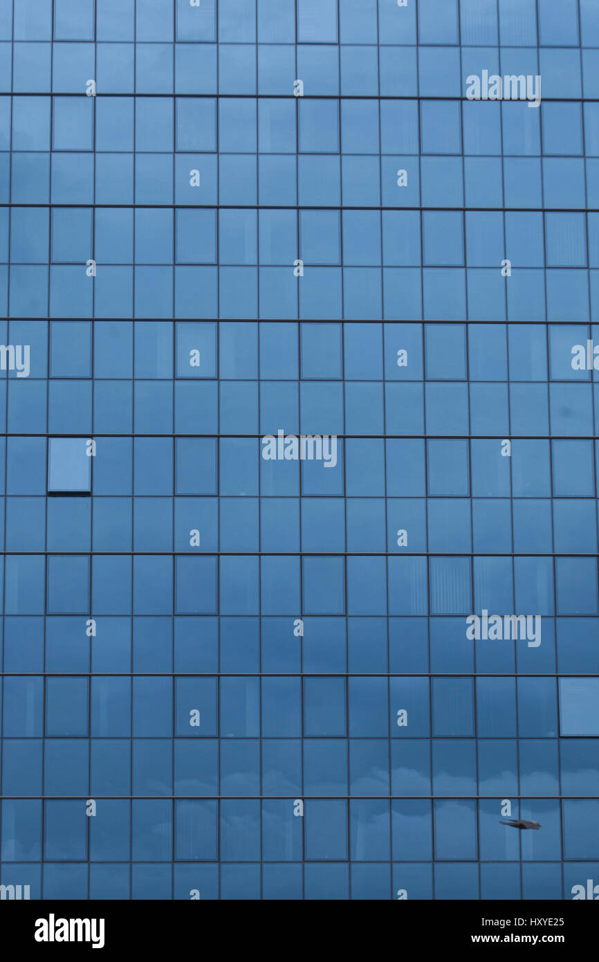 Sky reflecting in windows of office building Stock Photo - Alamy