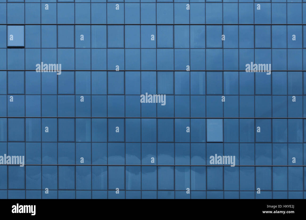 Sky reflecting in windows of office building Stock Photo - Alamy