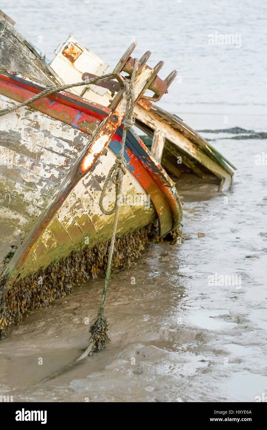 fishing boat wreck stranded in tidal mud Stock Photo