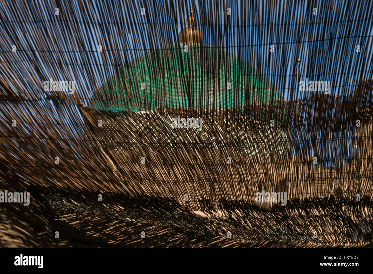 A dome with an Islamic motif seen through reed slats in Khiva, northern Uzbekistan Stock Photo