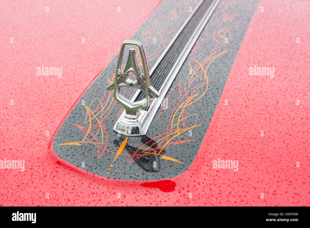 Rushmoor, UK - April 3, 2015: Closeup of a vintage American vehicle hood ornament covered in raindrops. Stock Photo