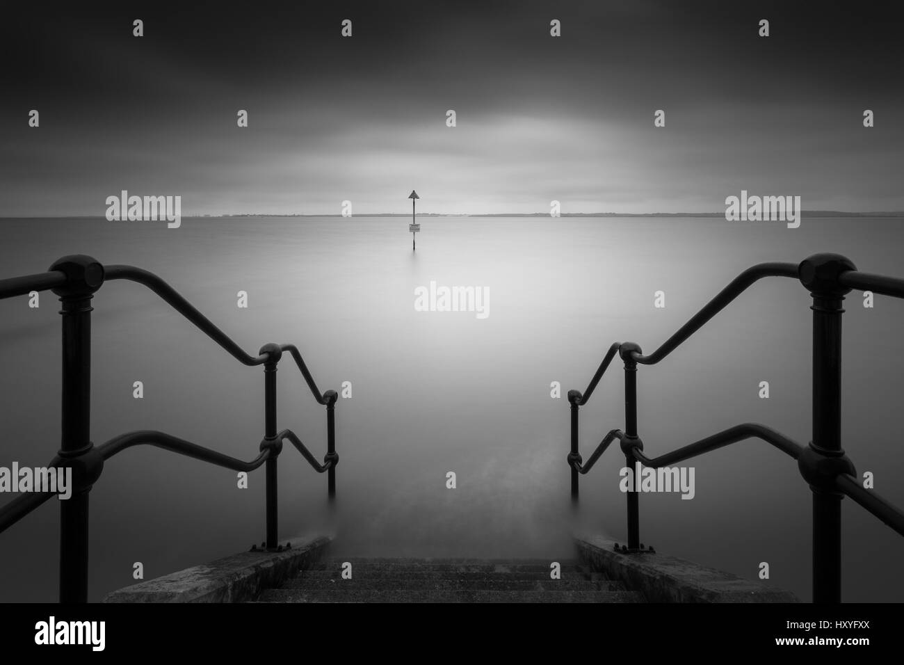 Stairs into the sea, long exposure Stock Photo