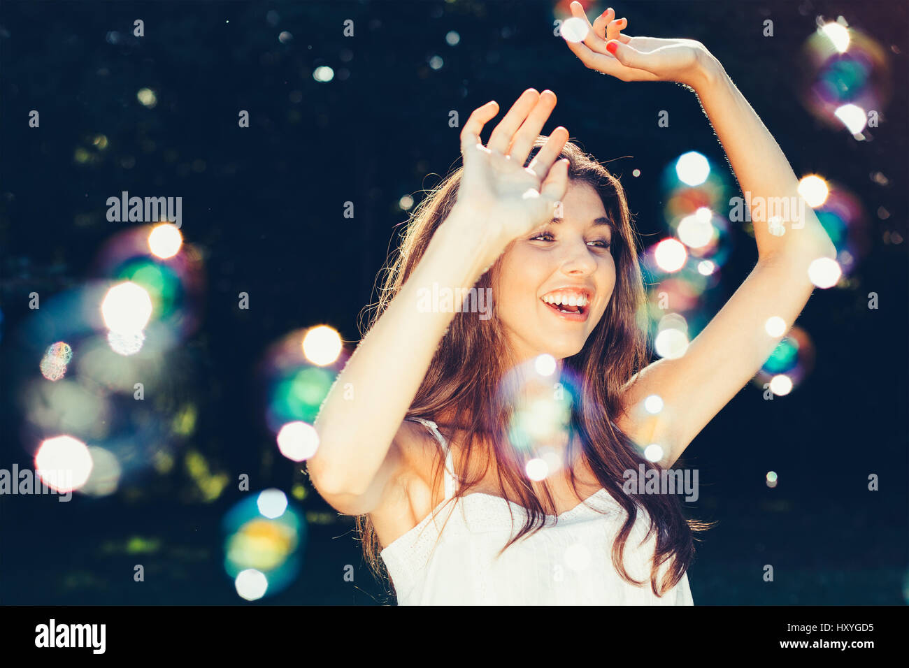 Happy girl dancing with bubbles outdoors Stock Photo Alamy