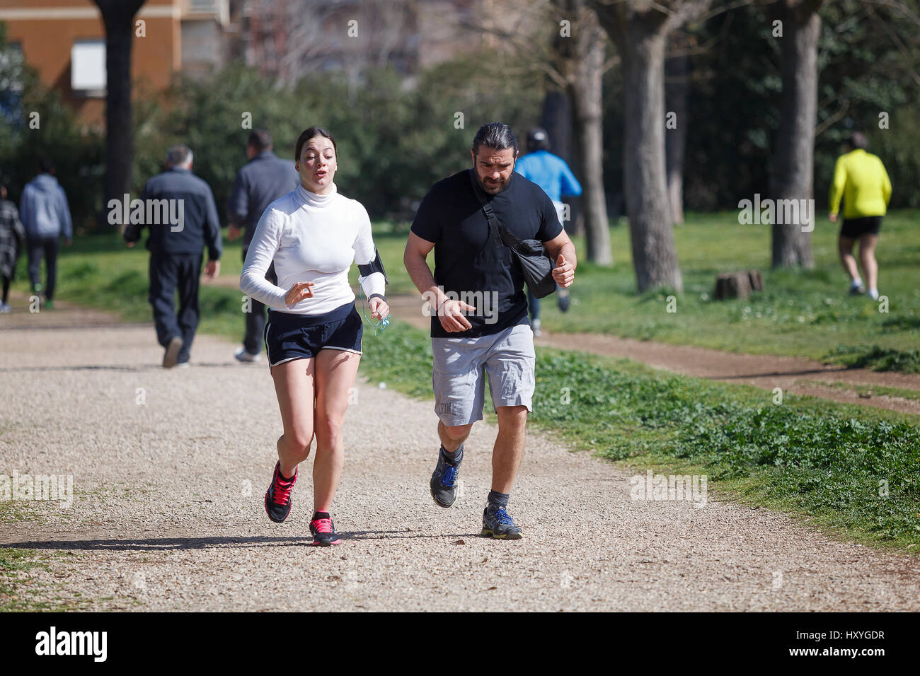 Rome, Italy - February 26, 2017: A man and a woman together are jogging in the park of Villa Gordiani, on a sunny spring day. Stock Photo
