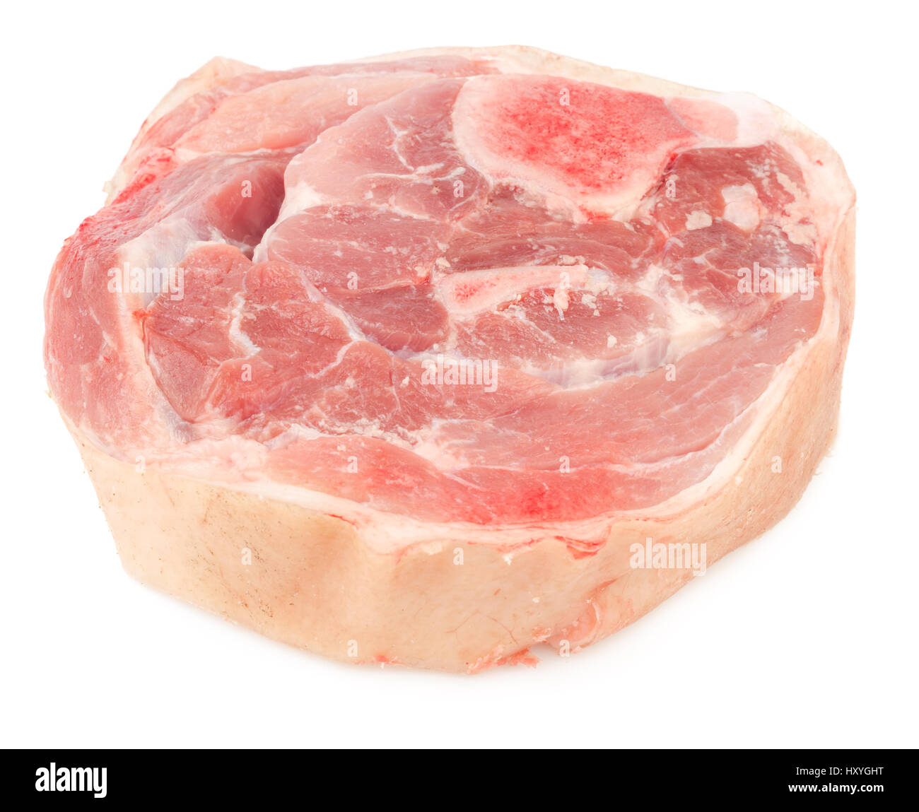 Natural dog food. Slice of raw pork meat with bone and skin isolated on white background. Stock Photo