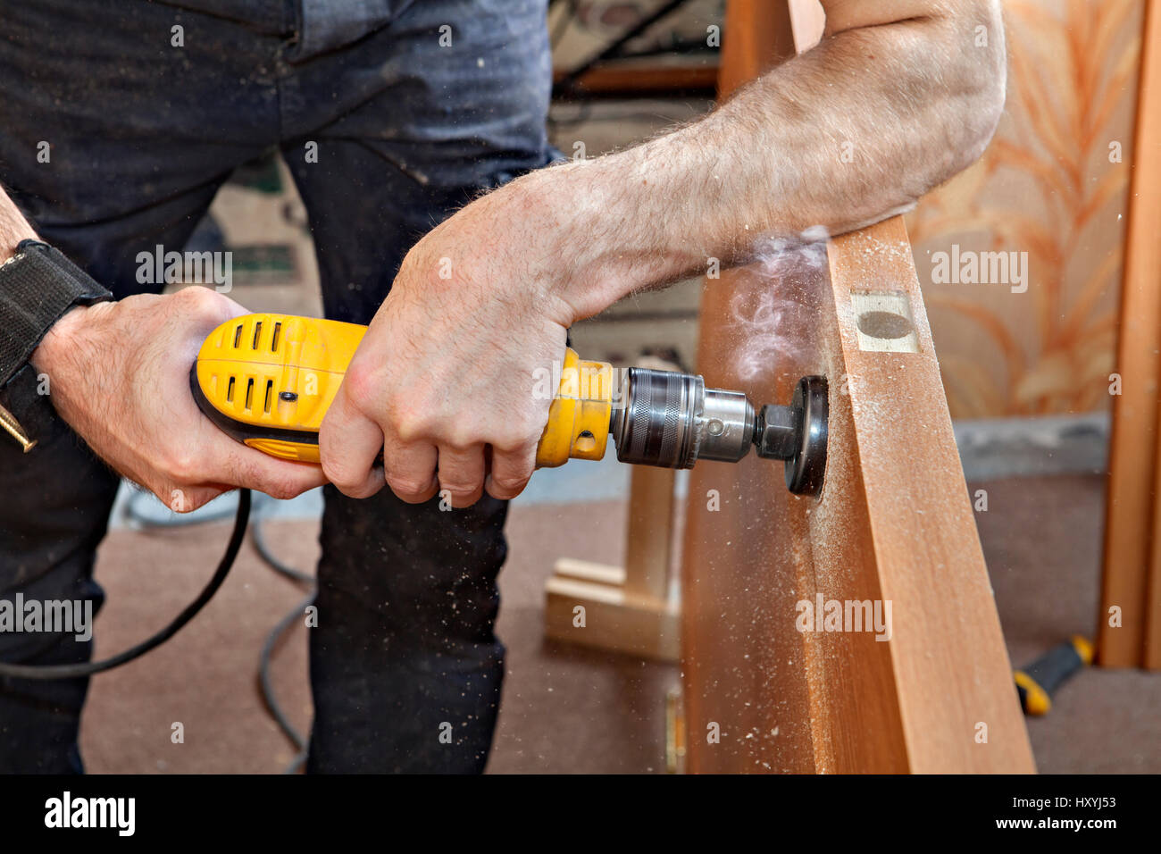 Installing doorknob, prepares door for knob and dead bolt, drilling