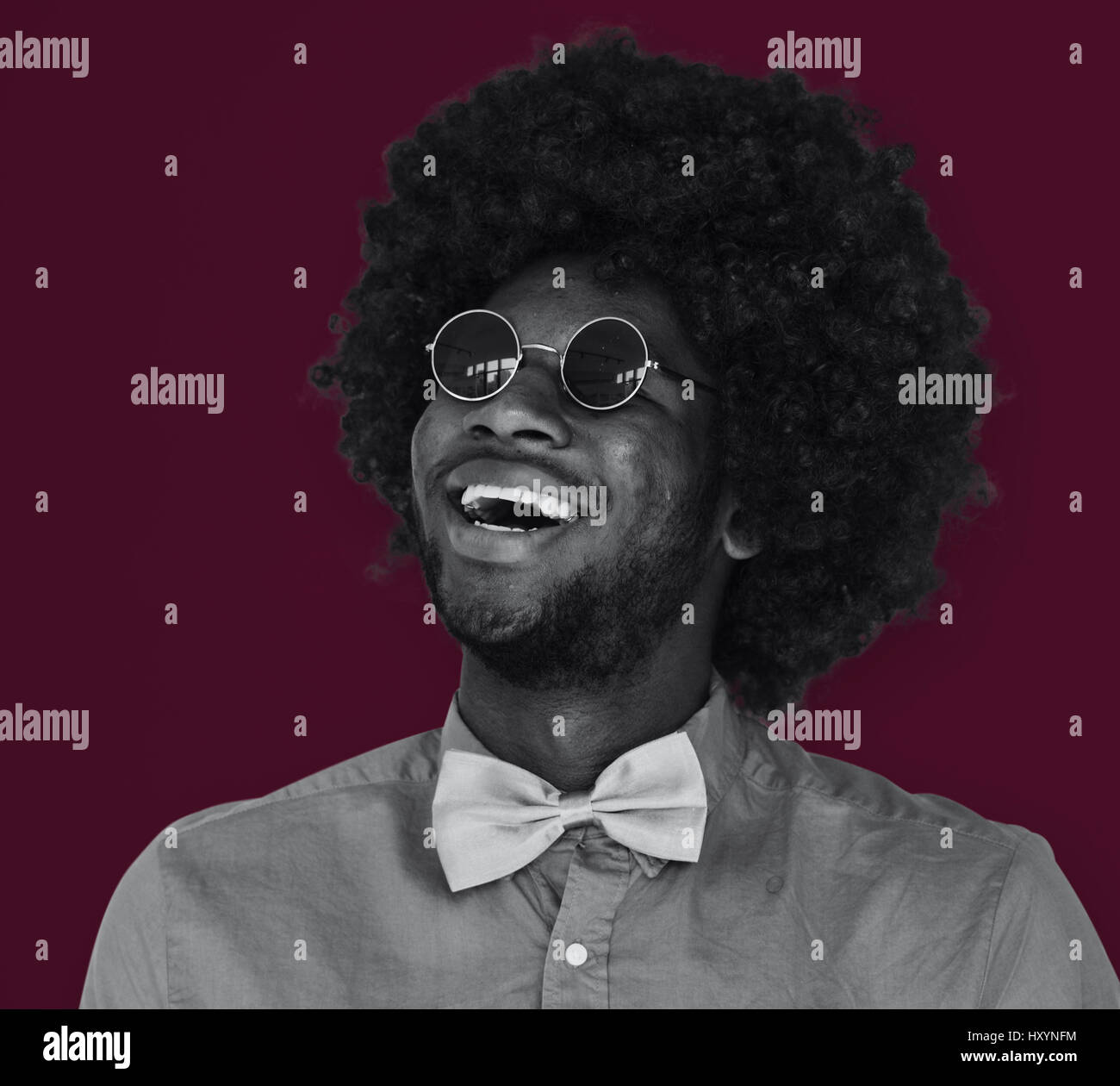 A Guy with a Black Afro Wig Smiling Stock Photo