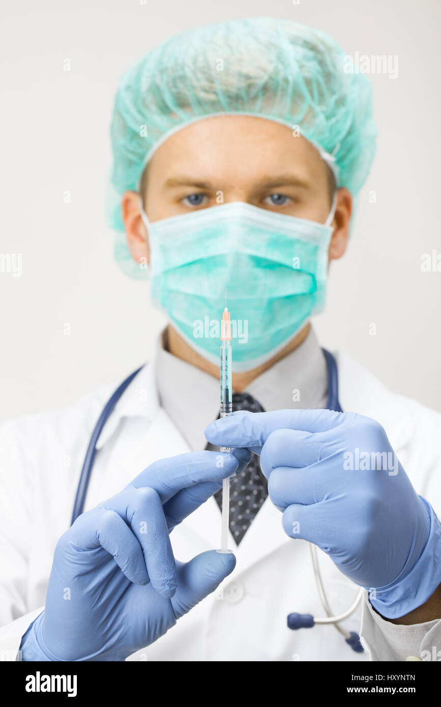 Both Hand Injection Doctor holding syringe with two hands and getting ready to make ...