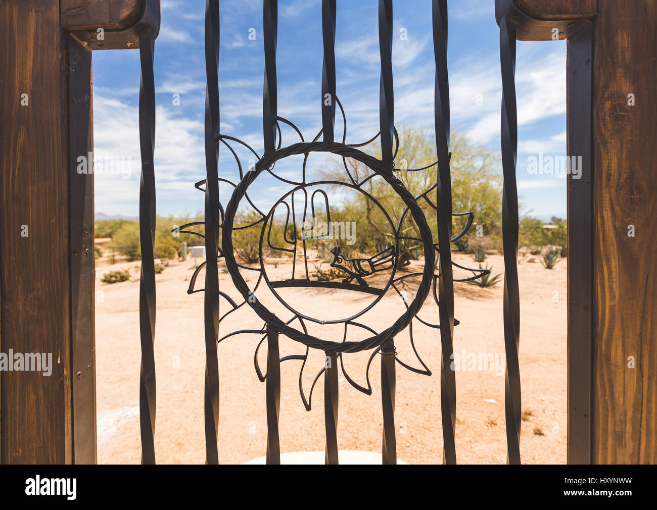 Outdoor gate with steel cactus and sun design. Stock Photo