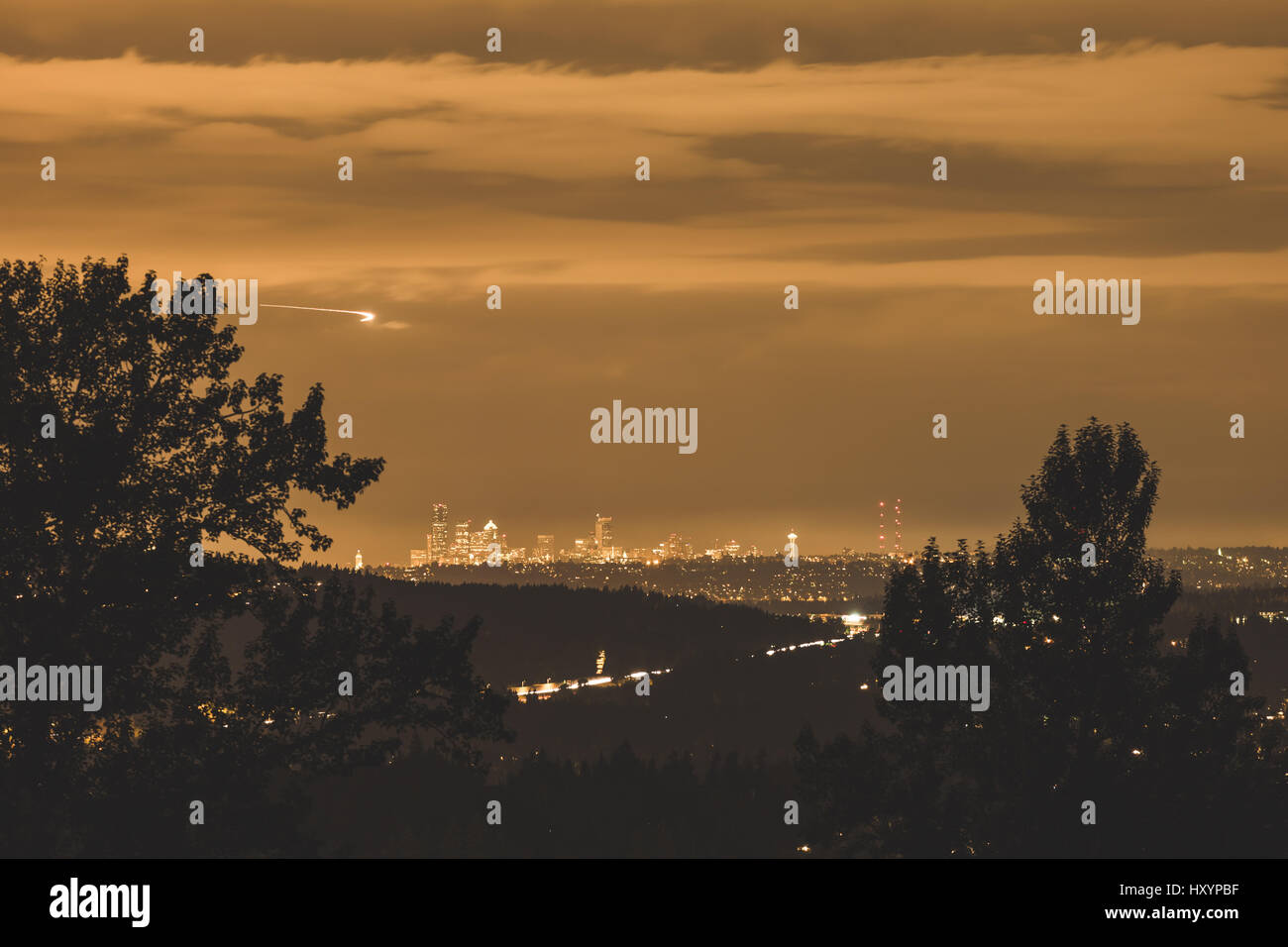 City lights, planes, clouds, and trees surrounding Seattle, Washington, USA. Stock Photo