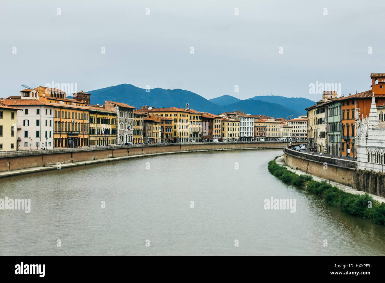 View of the River Arno in Italian City Pisa with Hills in the Distance Stock Photo