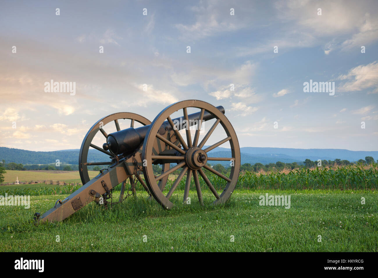 A cannon at Antietam (Sharpsburg) Battlefield in Maryland with the fence of Bloody Lane, also known as the Sunken Road in the middleground on the left Stock Photo