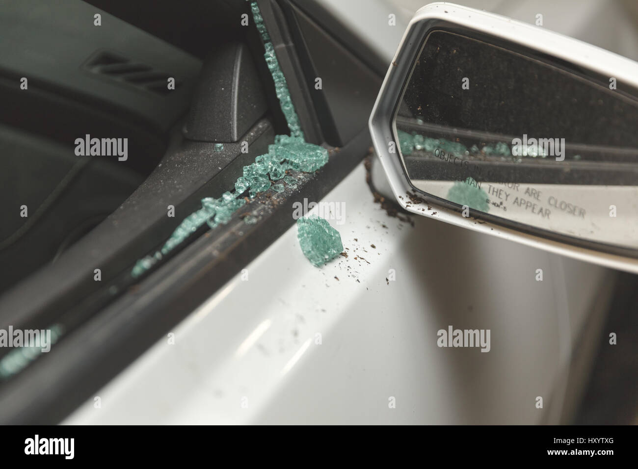 Close up of damage on a vehicle with its rightside window broken out