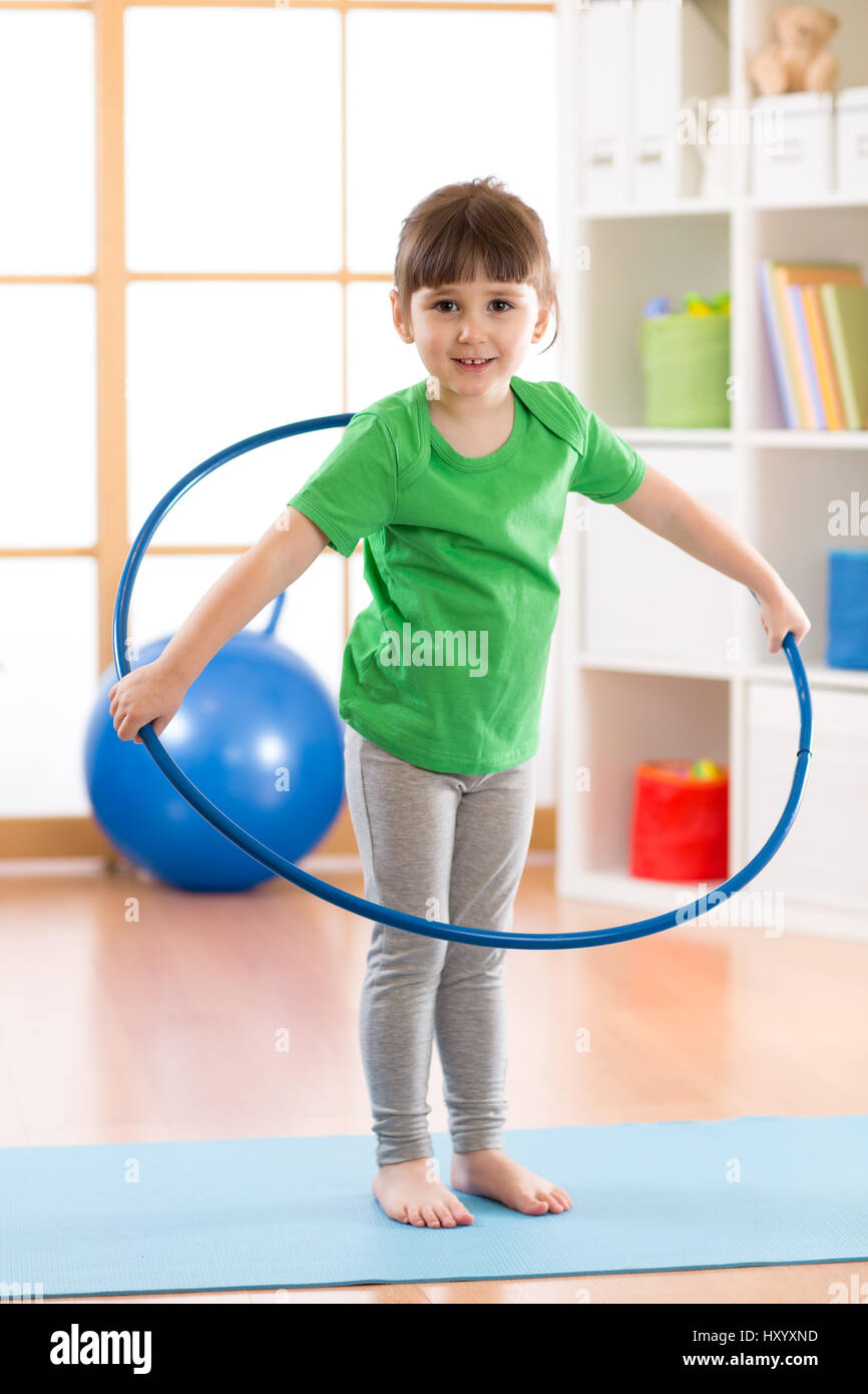 Little girl in pink clothes with hula hoop doing gymnastics, isolated on  white Stock Photo - Alamy