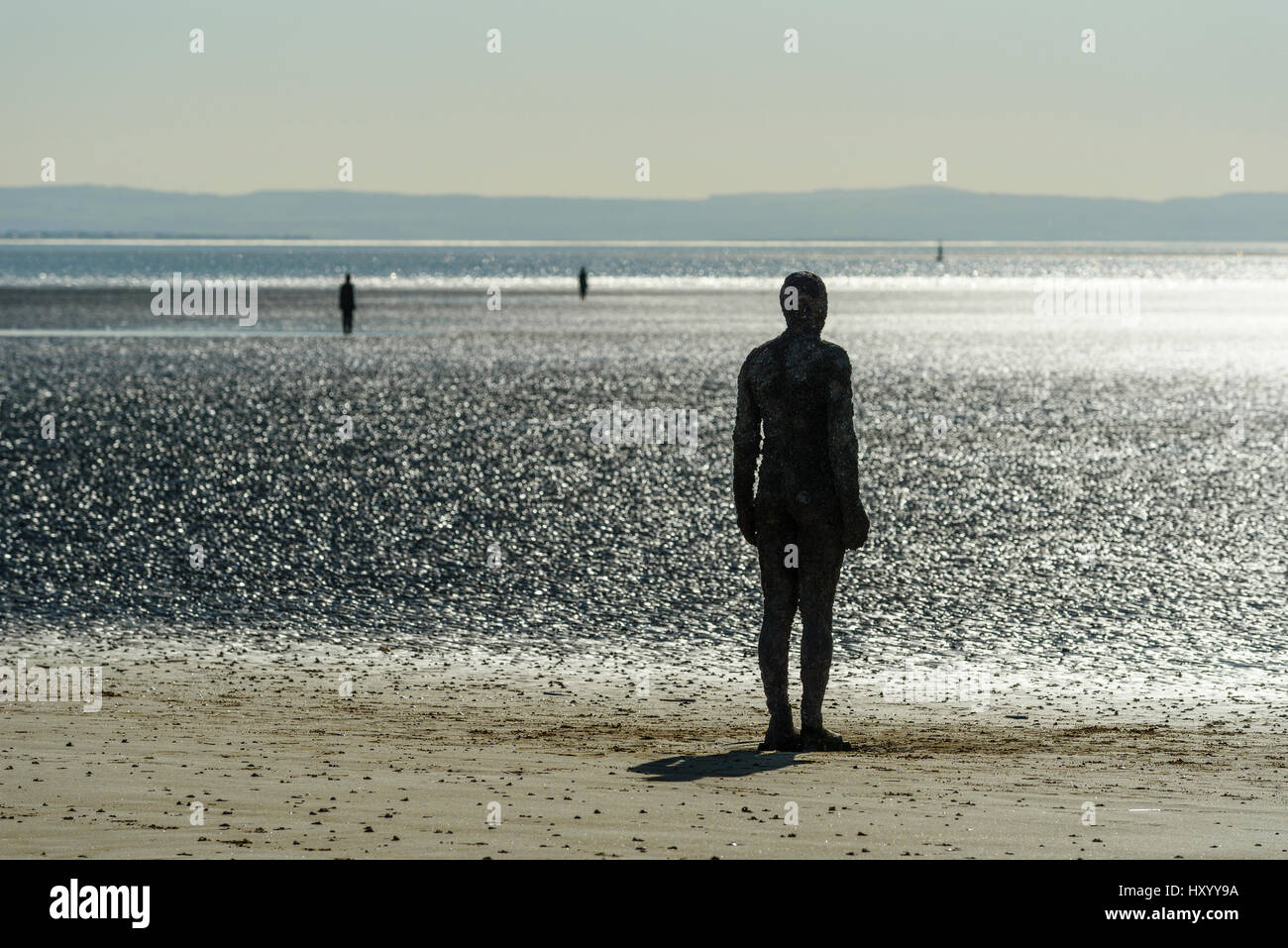 Some of the 100 cast-iron figures which make up Another Place by Anthony Gormley, Crosby Beach, Merseyside Stock Photo