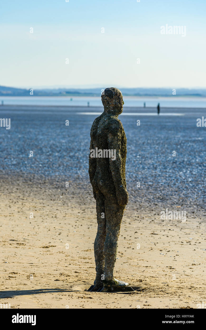 Some of the 100 cast-iron figures which make up Another Place by Anthony Gormley, Crosby Beach, Merseyside Stock Photo