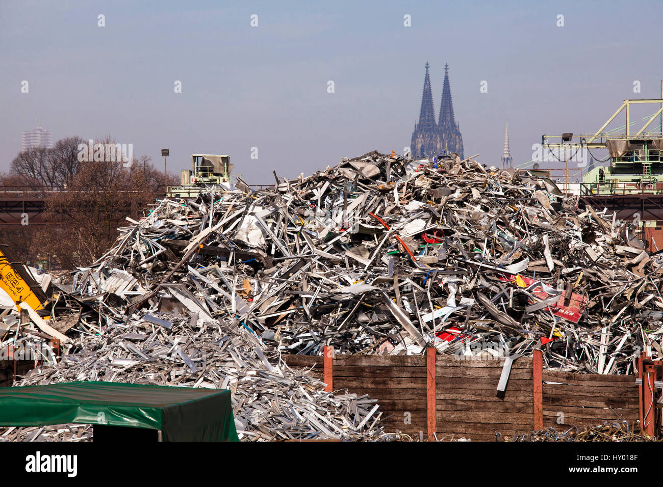 Germany,  Cologne, scrap yard with old metal in the district Deutz, in the background the cathedral. Stock Photo