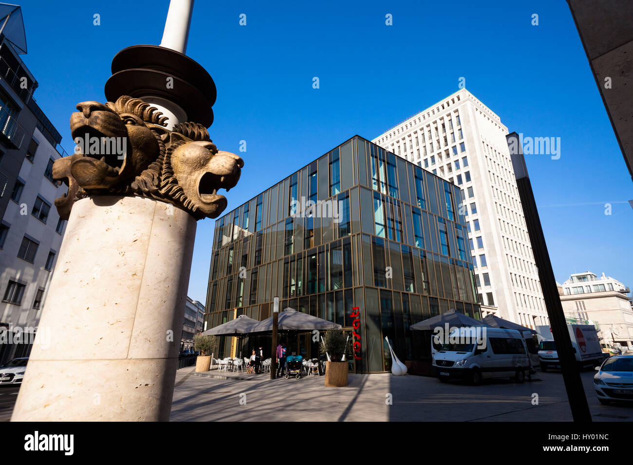 Germany,  Cologne, the building Torhaus at the Gerling Quartier, lion heads on a flagpole. Stock Photo