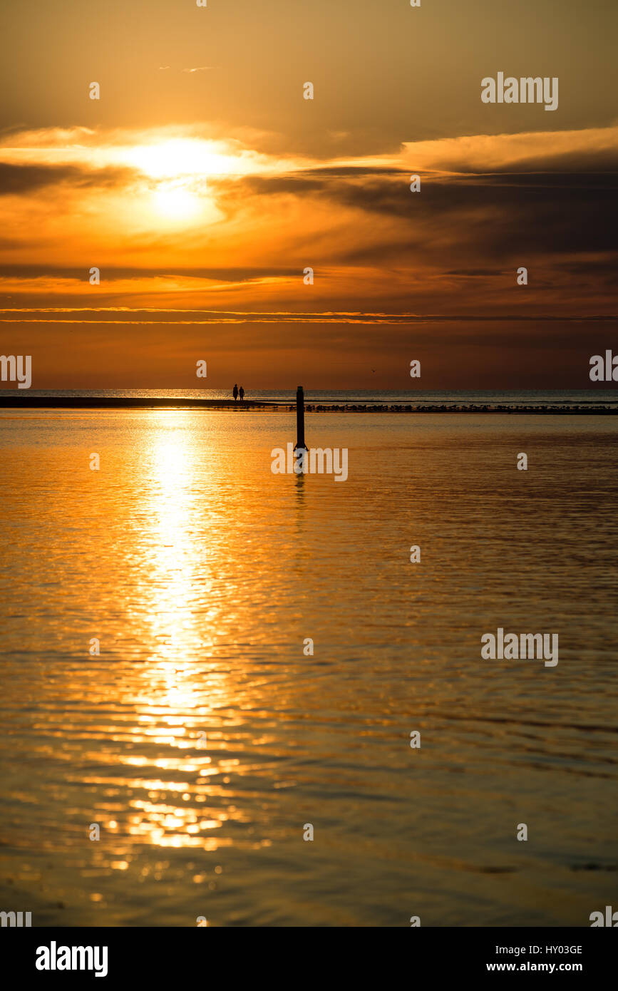 Beautiful sunset over the sea with clouds and reflections Stock Photo ...