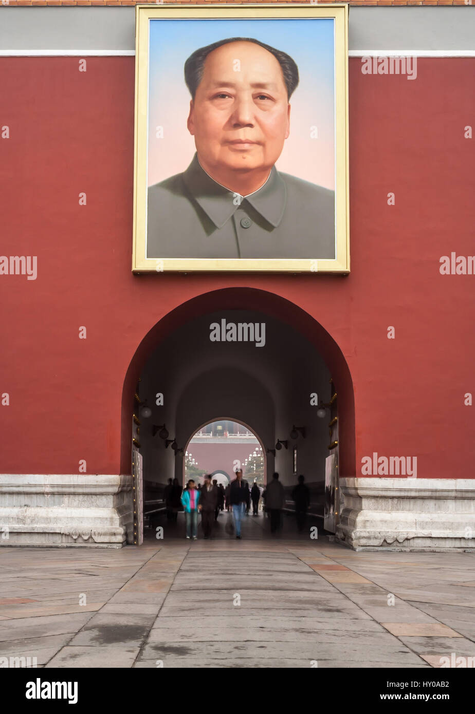 Unidentifiable tourists walk through the Tiananmen Gate of Heavenly Peace under the Portrait of Mao, Forbidden City, Beijing, China Stock Photo