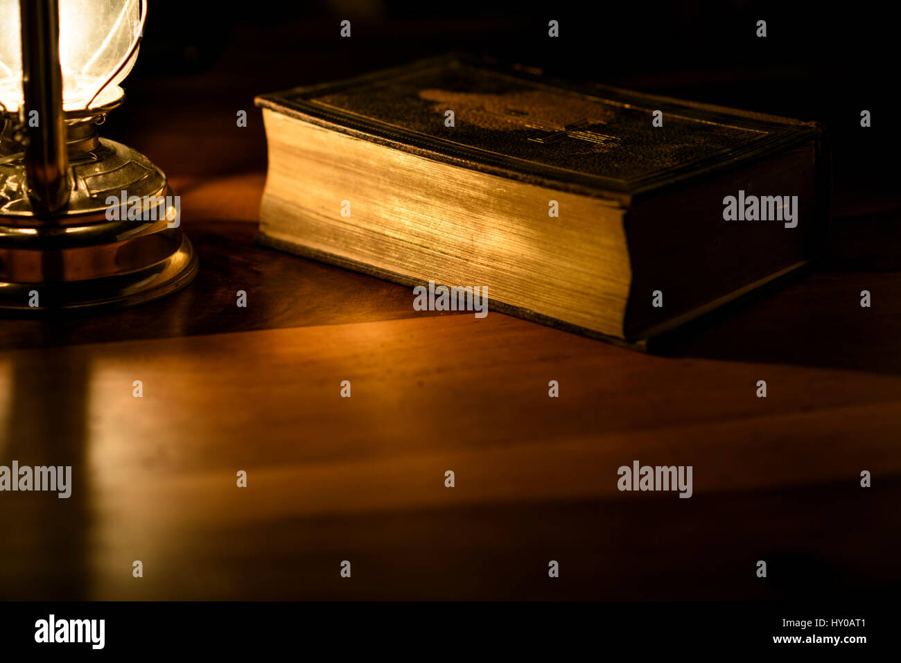 Bible in the light of an oil lamp Stock Photo Alamy