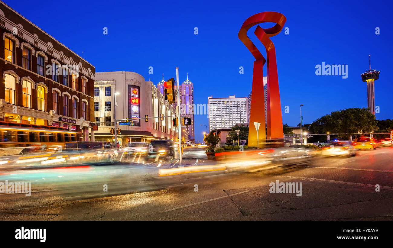 Downtown San Antonio, Texas as night falls with the Torch of Friendship sculpture and Tower of the Americas in the background Stock Photo