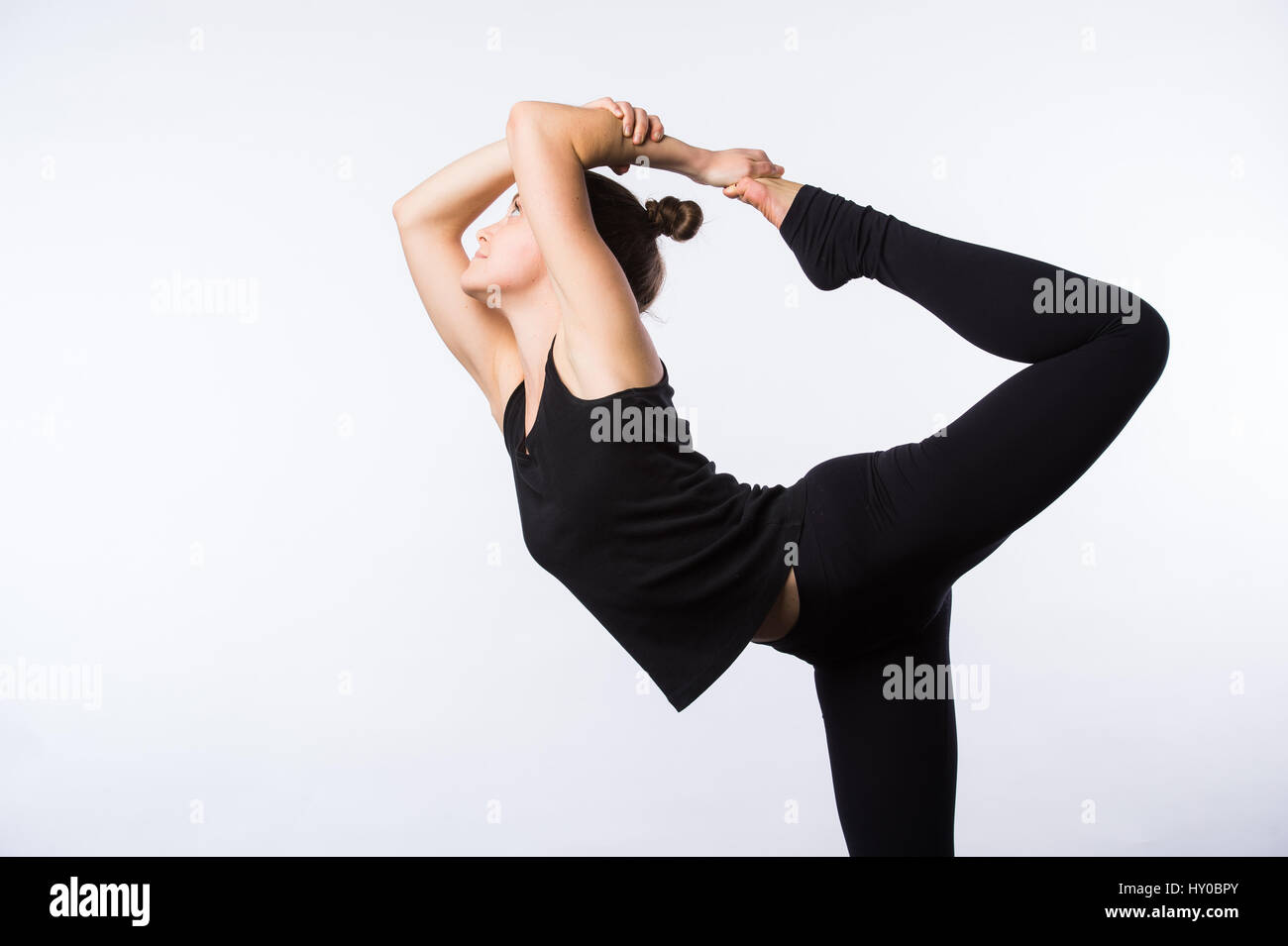 Attractive Woman doing Standing Bow Yoga Pose Stock Photo - Alamy