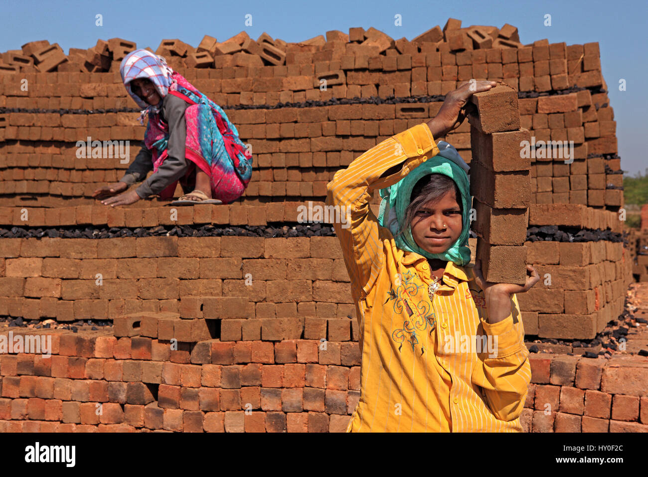 Girl holding bricks, barwani, madhya pradesh, india, asia Stock Photo