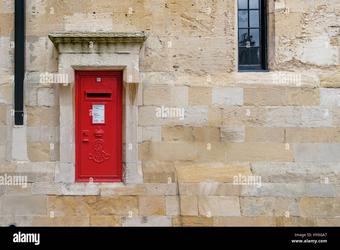 WINDSOR, UK - MARCH 18: A traditional iconic British post box in a stone wall in March 2017. Stock Photo